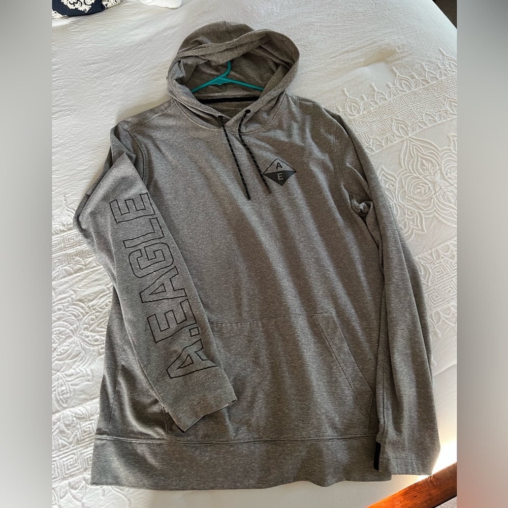 Men’s grey lightweight hooded American Eagle sweatshirt.  Size Medium Tall.